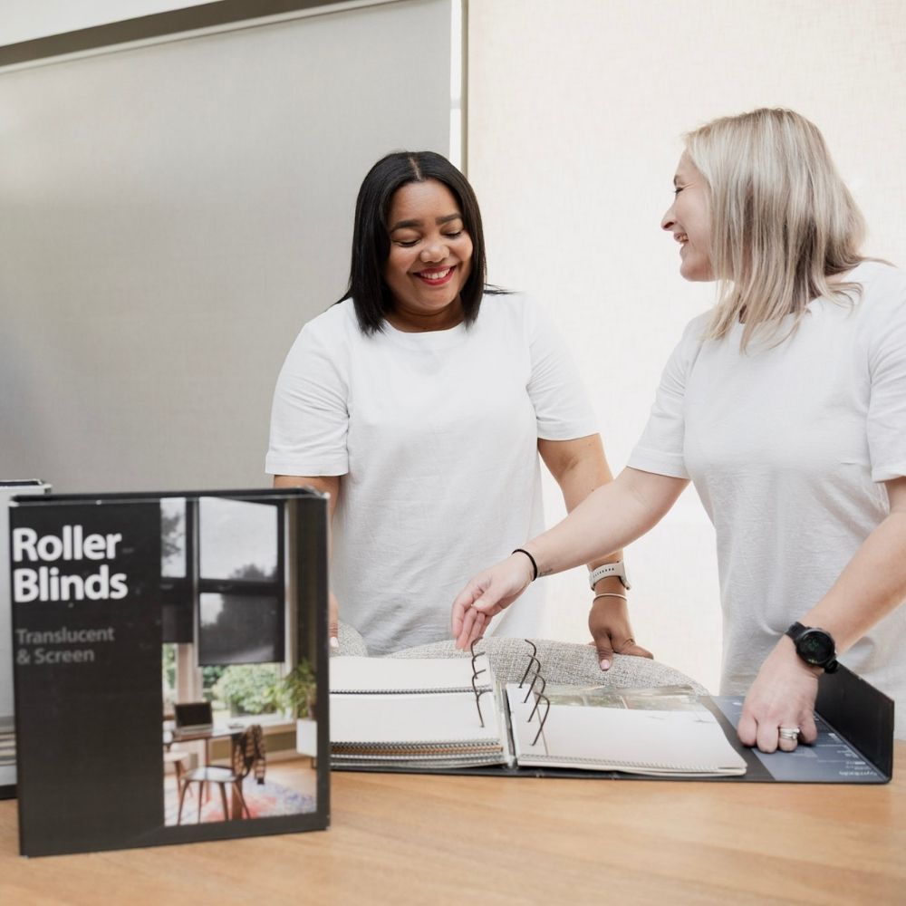 Nolans Knysna team members looking at roller blinds swatches