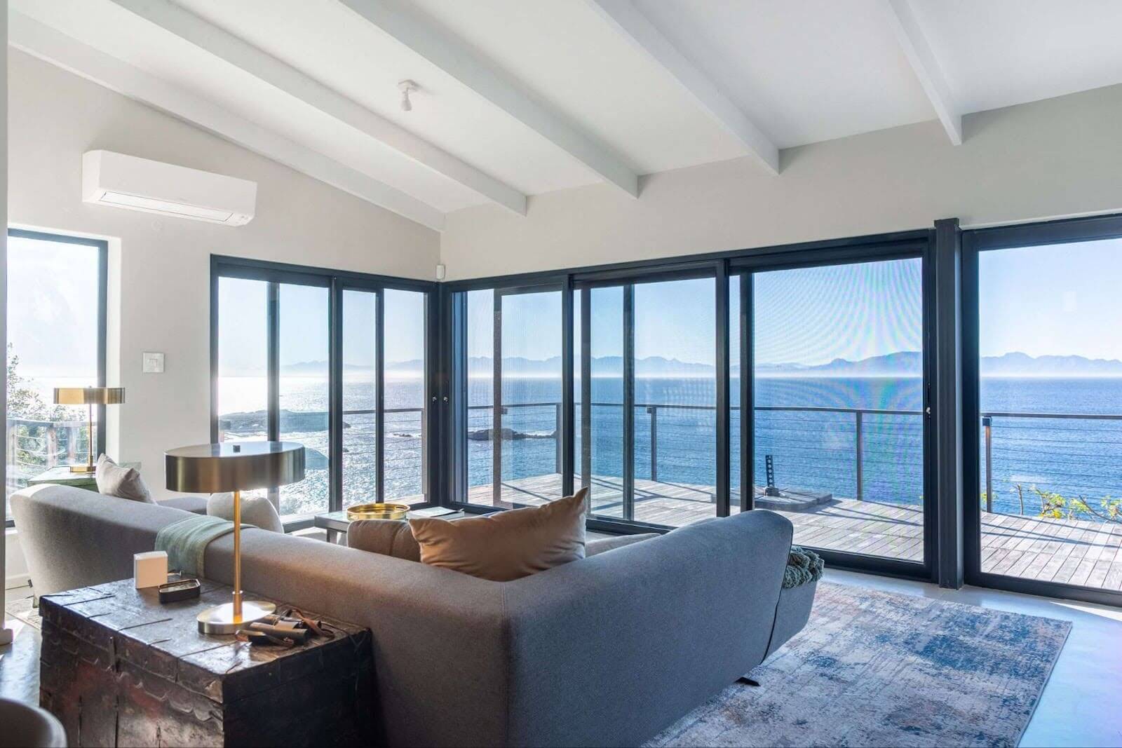 An insect screen installed on sliding doors leads onto a balcony and has unobstructed views of the ocean.